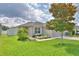 Beautiful single-story home featuring lush green lawn and mature tree in the front yard at 879 Orleans Dr, Eagle Lake, FL 33839