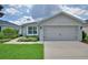 Charming single-story home with a well-maintained lawn and beautiful landscaping at 879 Orleans Dr, Eagle Lake, FL 33839