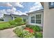 Charming house with fresh exterior paint, neat flower beds, and a paved walkway at 879 Orleans Dr, Eagle Lake, FL 33839