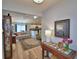 Open-concept living room with wood flooring, stylish furniture, and bright natural light at 879 Orleans Dr, Eagle Lake, FL 33839