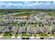 Bird's-eye perspective displaying the property within a community with manicured lawns and nearby amenities at 912 Scrub Oak Hammock Rd, Davenport, FL 33837