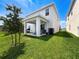 View of backyard featuring covered patio perfect for entertaining, with ample green space at 912 Scrub Oak Hammock Rd, Davenport, FL 33837