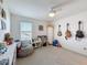 Bright bedroom area with carpet, ceiling fan, window, and charming musical decor at 912 Scrub Oak Hammock Rd, Davenport, FL 33837