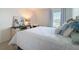 The bedroom features a bright window, a lamp, neutral carpet, and white walls at 912 Scrub Oak Hammock Rd, Davenport, FL 33837