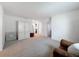 Spacious bonus room with neutral carpet, a brown leather chair and white cabinet at 912 Scrub Oak Hammock Rd, Davenport, FL 33837