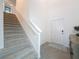 Spacious foyer with a staircase leading to the second floor, light tile flooring, and a white front door at 912 Scrub Oak Hammock Rd, Davenport, FL 33837