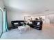 Open-concept living room with tile flooring, patio access, and seamless flow into the dining area at 912 Scrub Oak Hammock Rd, Davenport, FL 33837