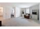Loft with plush carpeting, comfortable armchair, and built-in bookcases at 912 Scrub Oak Hammock Rd, Davenport, FL 33837