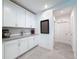 Walk-in pantry features white cabinets, granite countertops, tile flooring, and convenient access to the kitchen at 912 Scrub Oak Hammock Rd, Davenport, FL 33837