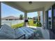 View of the covered patio with lounge chair, outdoor rug and grill, perfect for relaxation at 912 Scrub Oak Hammock Rd, Davenport, FL 33837