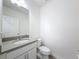 Neat powder room featuring a sleek vanity with a sink and fixtures, plus a toilet at 912 Scrub Oak Hammock Rd, Davenport, FL 33837