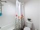 Clean bathroom featuring a shower/tub with a floral shower curtain at 912 Scrub Oak Hammock Rd, Davenport, FL 33837
