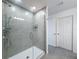 Modern shower with glass enclosure, gray tile, rainfall shower head and toiletry nook at 912 Scrub Oak Hammock Rd, Davenport, FL 33837