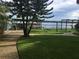 Lush backyard with manicured lawn and paved pathway leading to the dock and waterfront at 9402 Cat Track Trl, Lake Wales, FL 33898