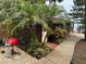 Outdoor shed featuring lush landscaping including palm trees and tropical plants at 9402 Cat Track Trl, Lake Wales, FL 33898