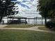 Landscaped backyard features a waterfront dock and lush green lawn at 9402 Cat Track Trl, Lake Wales, FL 33898