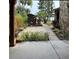 Landscaped backyard featuring a stone exterior and paver patio with a grill at 9402 Cat Track Trl, Lake Wales, FL 33898