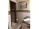 Elegant bathroom with stone tiled backsplash, decorative accents, and modern fixtures at 9402 Cat Track Trl, Lake Wales, FL 33898