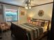 Bedroom with wood floors, large window, and decorative mirror at 9402 Cat Track Trl, Lake Wales, FL 33898