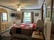 Bedroom with a decorative bedspread, modern fan, and a bright window at 9402 Cat Track Trl, Lake Wales, FL 33898