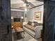 Bedroom with a barn door, futon, and desk with a TV for a cozy feel at 9402 Cat Track Trl, Lake Wales, FL 33898