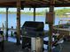 Outdoor kitchen with grill overlooking the water on private community dock at 9402 Cat Track Trl, Lake Wales, FL 33898