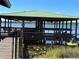 Dock, and waterfront area with a covered boat slip for enjoying lake activities at 9402 Cat Track Trl, Lake Wales, FL 33898