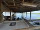Dock featuring a sink, covered area, boat lift, and a picturesque waterfront backdrop perfect for recreation and relaxation at 9402 Cat Track Trl, Lake Wales, FL 33898