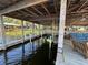 Covered dock with personal watercraft lift and relaxing seating area by the calm waters at 9402 Cat Track Trl, Lake Wales, FL 33898