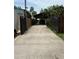 Long driveway has a closed metal gate at the road and leads to the carport at 9402 Cat Track Trl, Lake Wales, FL 33898