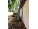Side view of the AC unit on the exterior of the home with green foliage at 9402 Cat Track Trl, Lake Wales, FL 33898