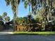 Serene home with mature trees, gated driveway, and lush landscaping, blending privacy and curb appeal at 9402 Cat Track Trl, Lake Wales, FL 33898