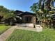 Charming home exterior with stone accents, surrounded by lush landscaping and a well-manicured lawn at 9402 Cat Track Trl, Lake Wales, FL 33898