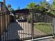 Front entrance showcasing a gated driveway leading to the home and surrounding greenery at 9402 Cat Track Trl, Lake Wales, FL 33898
