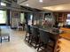 Open kitchen with granite counters, island seating, and stainless steel refrigerator at 9402 Cat Track Trl, Lake Wales, FL 33898