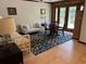 Cozy living room features tile floors, neutral-toned furniture, and a view of the outdoors at 9402 Cat Track Trl, Lake Wales, FL 33898