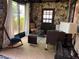 Unique living room featuring stone accent walls, modern furniture, and natural light at 9402 Cat Track Trl, Lake Wales, FL 33898