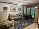 Living room featuring daybed, ceiling fan, and access to backyard with trees at 9402 Cat Track Trl, Lake Wales, FL 33898