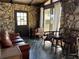 Stone walled room with a unique floor, rustic feel, and comfortable furnishings at 9402 Cat Track Trl, Lake Wales, FL 33898