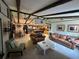 Inviting living room with exposed beam ceilings and an open floor plan to the kitchen and dining area at 9402 Cat Track Trl, Lake Wales, FL 33898