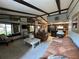Inviting living room with beamed ceiling, large windows offering natural light and beautiful views, and comfortable seating at 9402 Cat Track Trl, Lake Wales, FL 33898