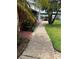 Walkway from the home leads to a lakeside dock with a covered structure at 9402 Cat Track Trl, Lake Wales, FL 33898
