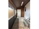 Covered back patio with decorative flooring and outdoor access at 9402 Cat Track Trl, Lake Wales, FL 33898
