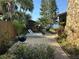 Charming stone home featuring a patio with outdoor grill and lounge chairs overlooking the water at 9402 Cat Track Trl, Lake Wales, FL 33898