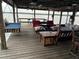 Cozy covered dock with ample seating and views of the water at 9402 Cat Track Trl, Lake Wales, FL 33898