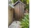 Outdoor wooden shed with moon emblem and an alligator statue mounted to the fence at 9402 Cat Track Trl, Lake Wales, FL 33898