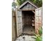 Outdoor wooden shed with open doors revealing empty storage space and shelving at 9402 Cat Track Trl, Lake Wales, FL 33898