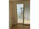 Sliding glass door with blinds leads to patio with view of waterfront at 9402 Cat Track Trl, Lake Wales, FL 33898