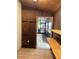 Wood paneled storage room interior with wood shelves and vinyl flooring at 9402 Cat Track Trl, Lake Wales, FL 33898