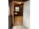 Interior view of storage room features wood walls, shelves, and window at 9402 Cat Track Trl, Lake Wales, FL 33898